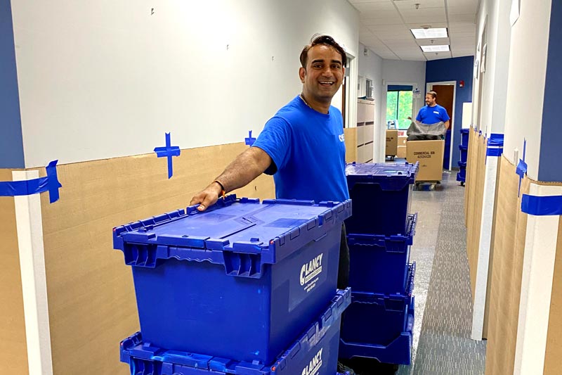 Movers moving blue containers