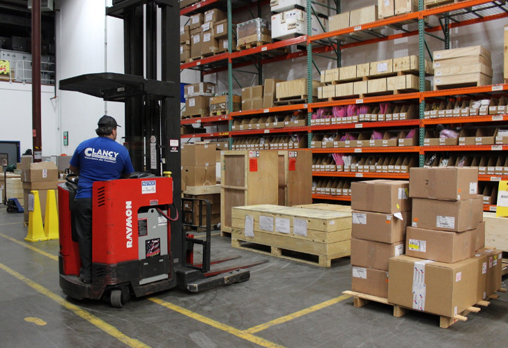 Clancy warehouse employee is arranging storage items