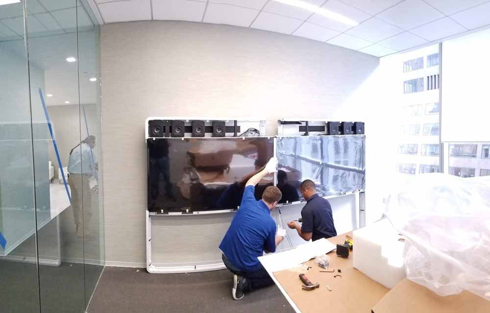 Office movers carefully moving fragile object