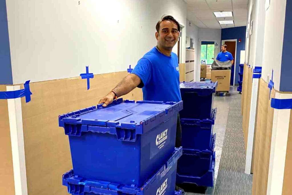 Men smiling while packing stuff