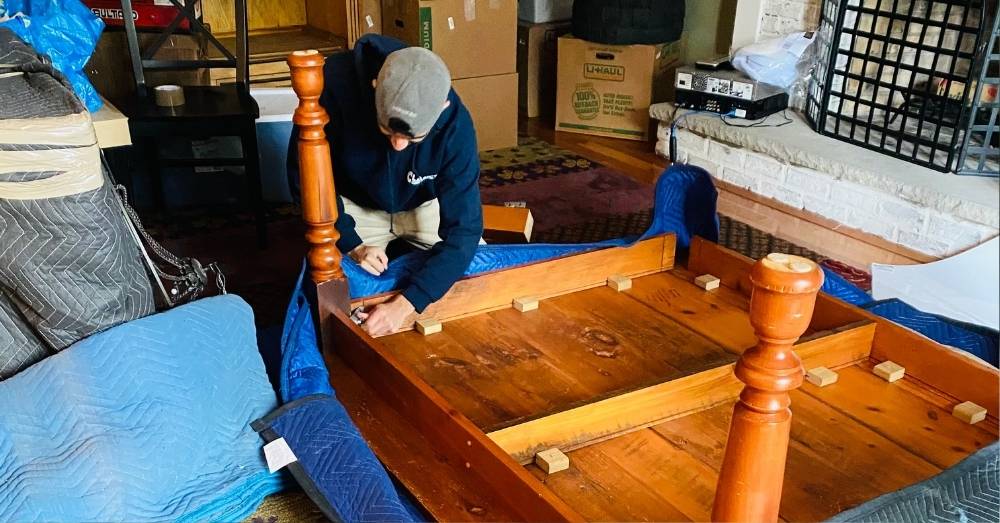 Mover doing furniture disassemble and installation