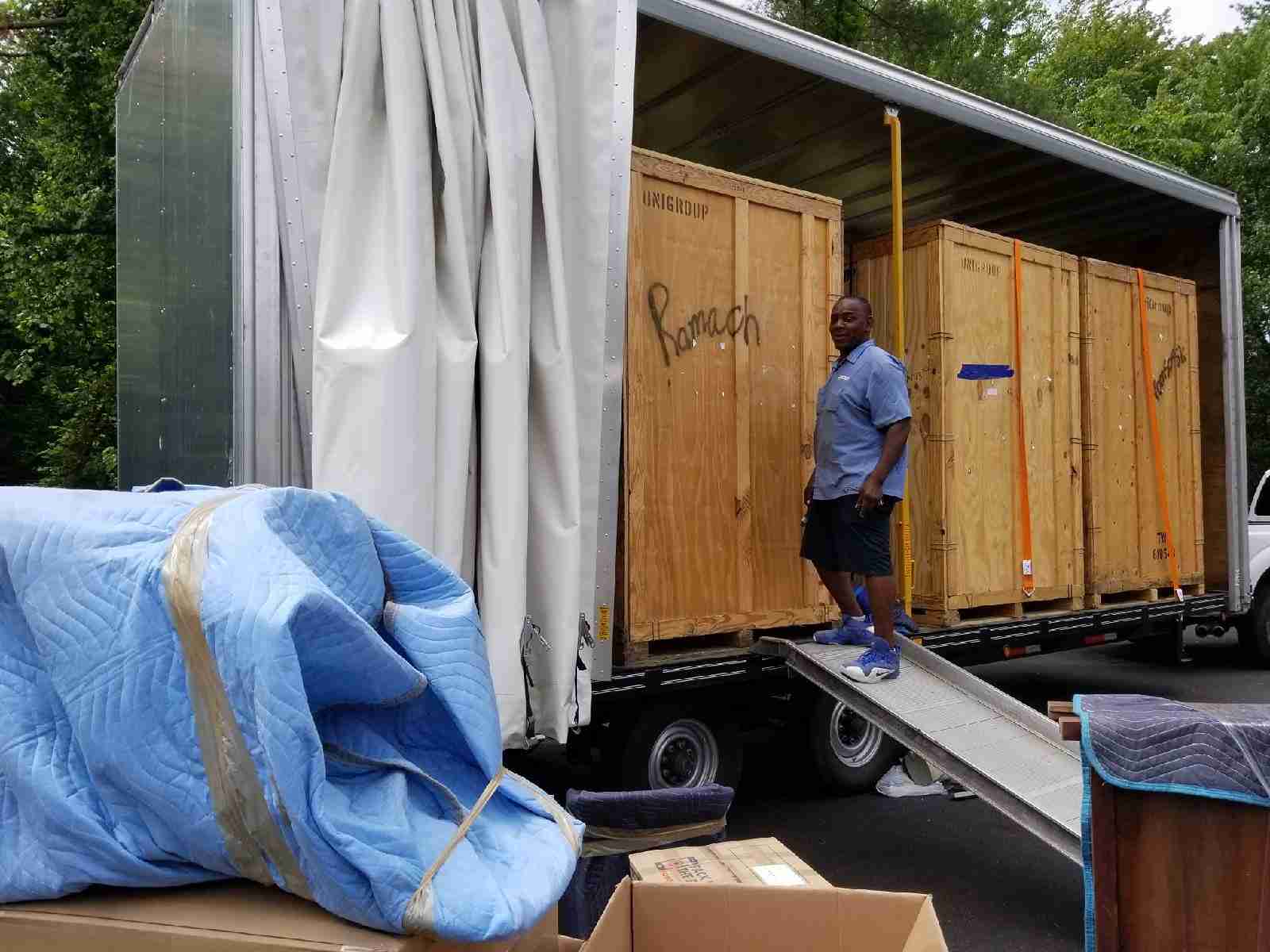 person checking the packages inside the moving truck