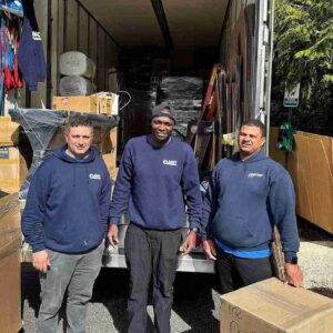 movers team standing behind the moving truck