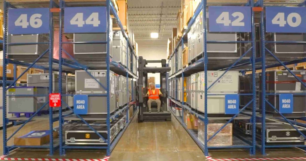 man driving forklift inside warehouse
