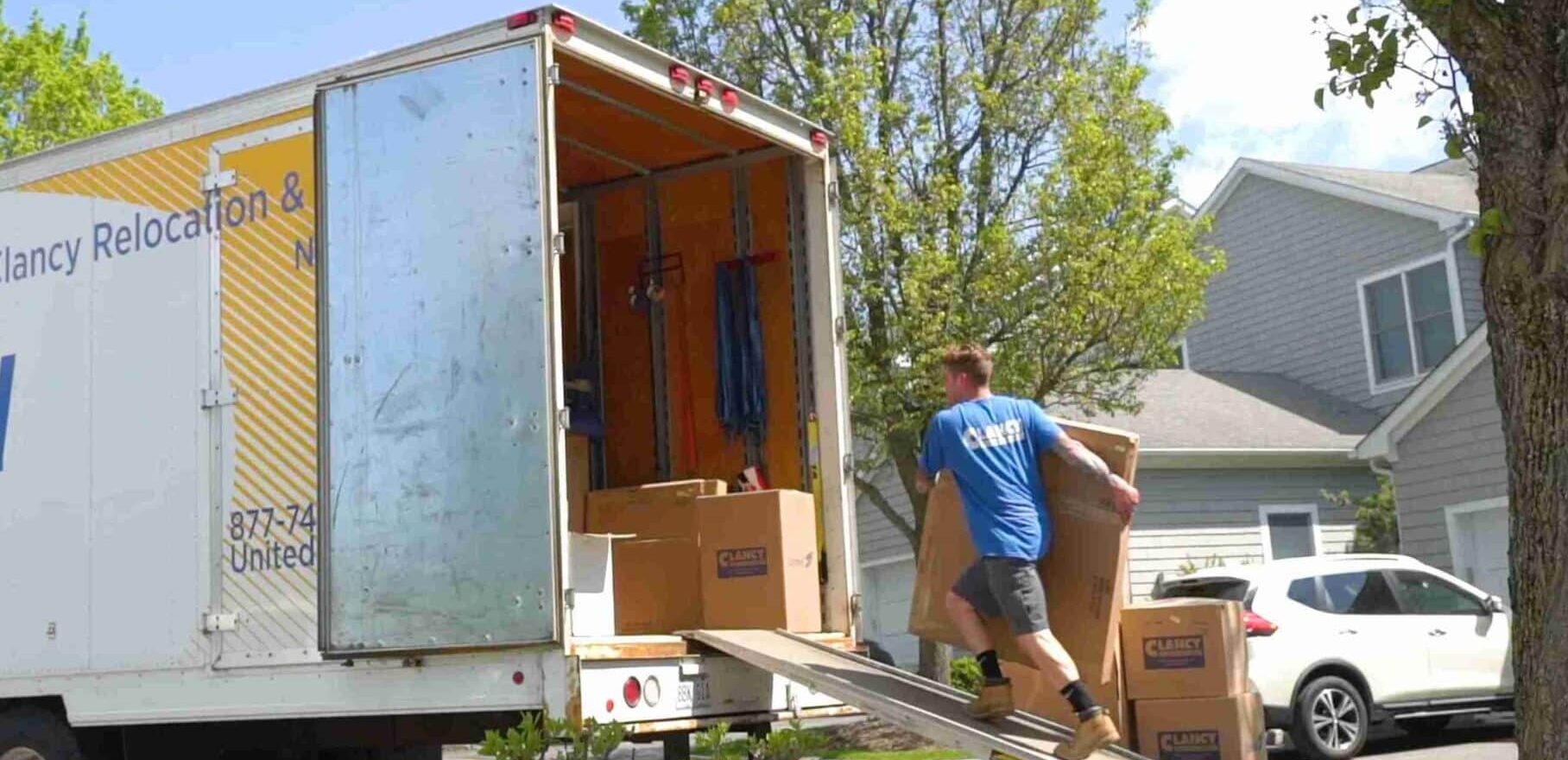 man carrying a package into the truck