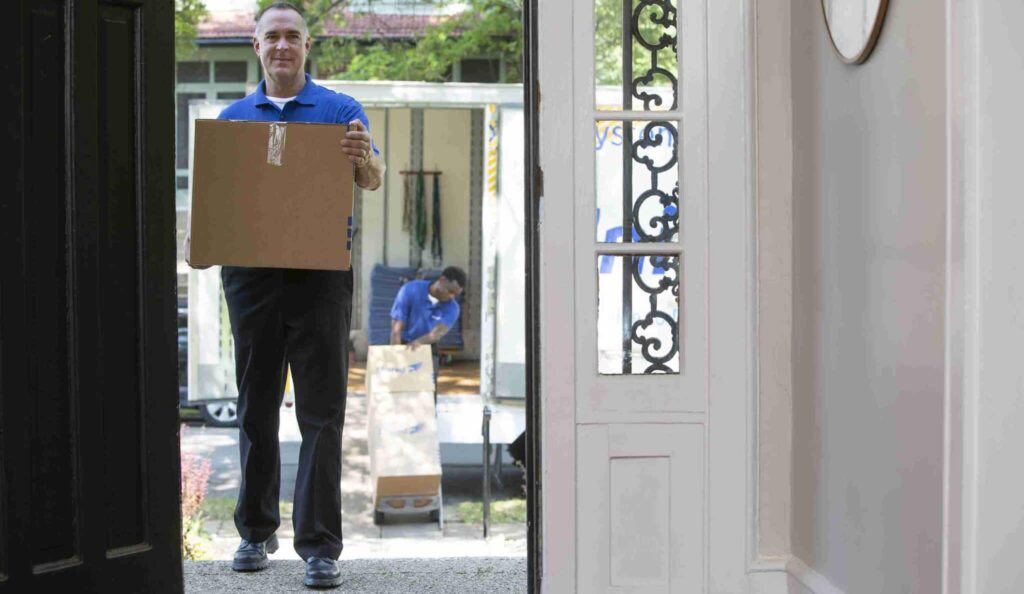 mover carrying package into the house