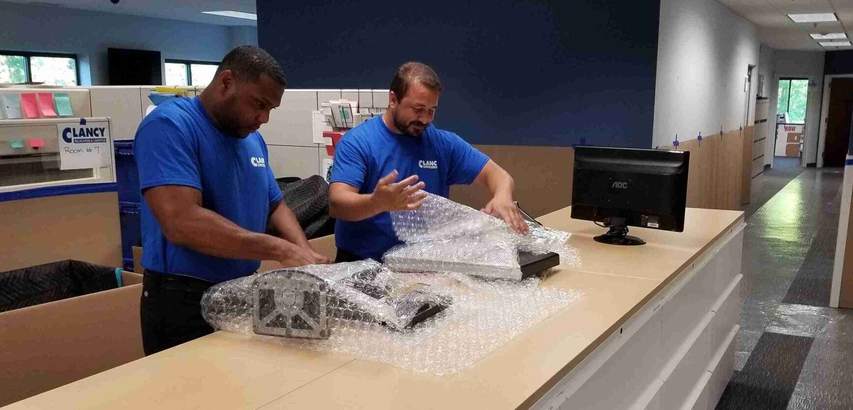 movers bubble wrapping the monitors