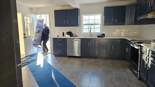 Mover carrying a box from kitchen door